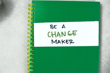 Green notebook labelled Be a Change Maker