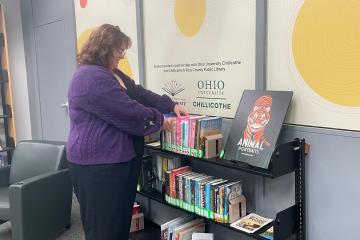 Emma Adams browses the community collection at Quinn Library