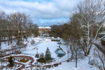 A view of snowy campus with Emeriti Park in the foreground