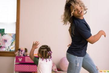 Kelley Brumfield, BSS ’16, dances with her daughter