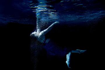 women swimming underwater