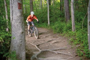 Danny Twilley rides his bicycle on a mountain bike trail
