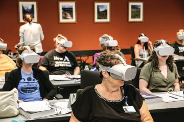 In August, community health worker trainees use virtual reality tech to immerse themselves in the impact of Narcan, an anti-overdose drug. Photo by Ellee Achten, BSJ '14, MA '17 