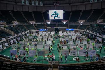 a wide view of student presentations displayed on the center floor of Ohio University's Convocation Center
