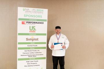 Chef Mike Rodriguez poses with his National Association of College & University Food Services silver medal.