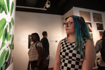 Students view the exhibit called Through the Survivors' Lens