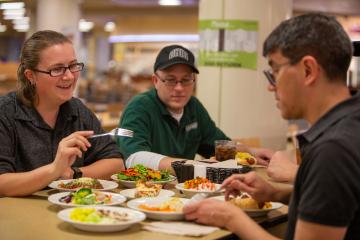 OHIO employees are shown eating in a dining hall