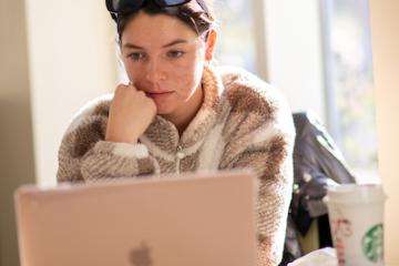 An OHIO student works on a laptop computer