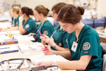 A row of OHIO nursing students engaged in classroom instruction