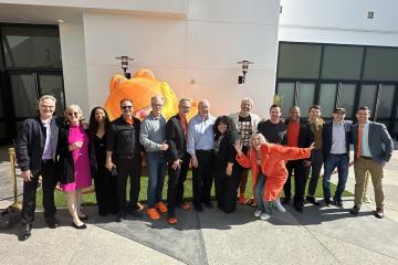 a group of movie industry professionals pose outside in front of an inflatable Garfield figure