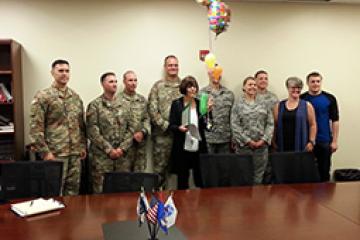 Ruth Bickle poses with Air Force and Army ROTC co-workers