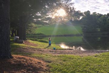 Young girl fishing on a pond in Appalachia