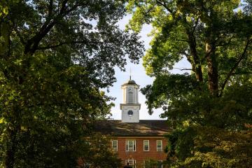Cutler Hall is shown surrounded  by trees