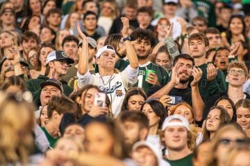 Bobcat fans cheer at a football game in Peden Stadium