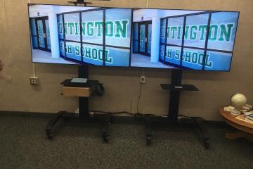 Video displays in a rally room at Huntington High School