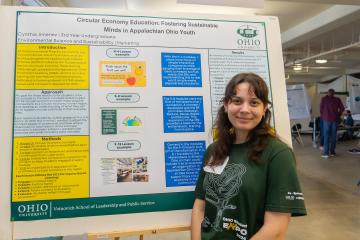 Cynthia Jimenez is shown with her Environmental Studies poster at the OHIO Research Fair