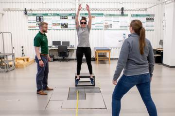 researchers in street clothes conduct a movement experiment