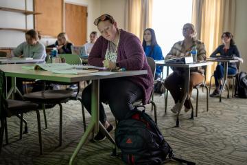 students sitting at tables in classroom