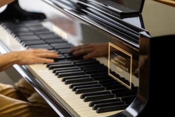 An OHIO student plays a piano that was donated in memory of Richard D. and Arlene M. Wetzel