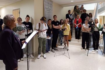 OHIO students, faculty and staff listen to a speaker in the Schoonover Center for the plaque dedication ceremony