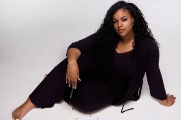 Hadiya Ray, seated on the floor with journals spread out in front of her