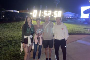 Samantha Fedoush, Victoria Swiler, Nathan Smith, and Michael Lane stand in front of a countdown clock