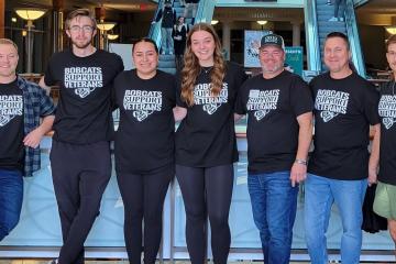 OHIO students and staff wear shirts that say "Bobcats Support Veterans" in the Baker University Center