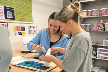 Bridget Burkett and Andie Miller working on their project in the CoLab Makerspace