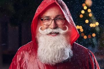Santa Claus is shown wearing rain poncho in this illustration
