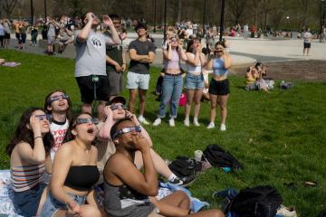 Students on the Ohio University campus watch the April 2024 solar eclipse