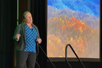 A speaker gives a presentation at the Summit on Sustainability