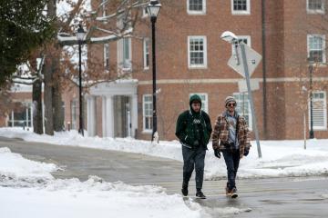 Students walk on OHIO's Athens Campus during snowy weather. 