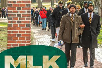 OHIO students and community members are shown taking part in the Silent March, and the letters MLK are in front of part of the image