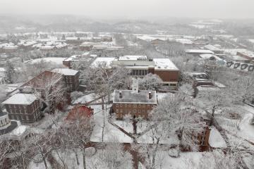 Cutler Hall,  the College Green and the trees and buildings nearby are covered in snow in this aerial image
