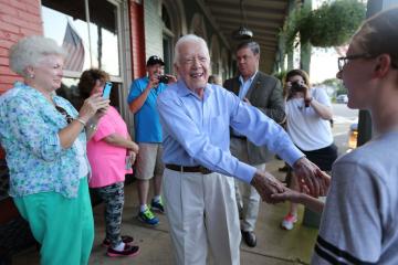 Jimmy Carter shakes hands with a small crowd