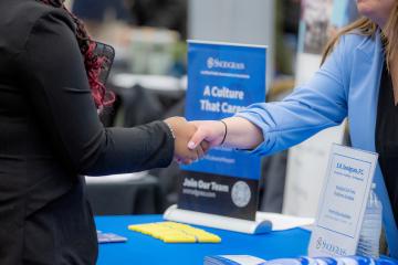 Two people shake hands at an Ohio University Career Fair