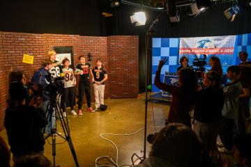 Students on set before recording a take