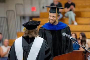 Dr. Roberta Milliken congratulates Dr. Michael Koop 