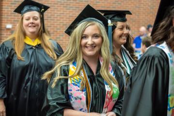 Graduates in caps and gowns smiling