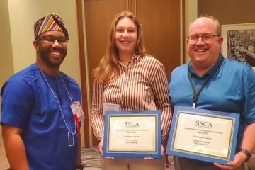 Cora Farra holds the Intercultural Communication Division Top Paper Award.