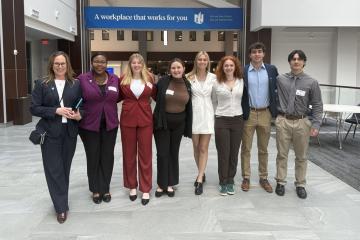 Two members of the Career Services team and six Russ College students pose for a photo inside the Nationwide Insurance headquarters building