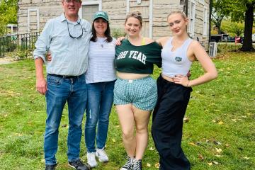 a father, mother and two daughters pose wearing ohio university attire