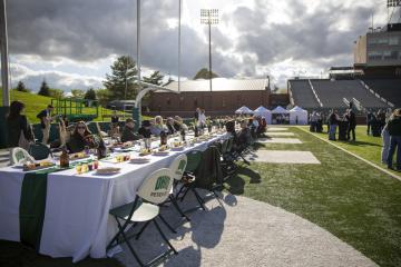 People sitting at a table at the Taste of Brewing event.