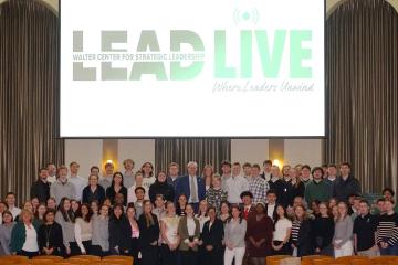 OHIO students, faculty and staff stand in front of the LEAD Live graphic in the Walter Rotunda