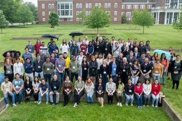 Participants in the Frontiers in Nuclear Astrophysics Meeting stand together for a photo outside on the Ohio University campus