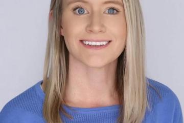 Headshot of Laura Holbrook, blonde hair wearing blue shirt