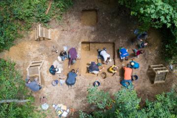 A group of students doing an archaeology dig.
