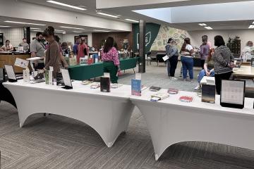 People look at the tables of books at the Banned Book Cafe event at Ohio University Zanesville in 2024