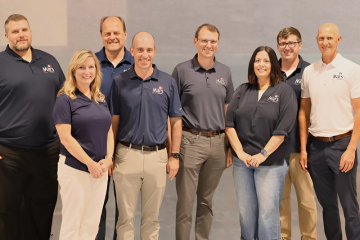 Eight representatives from Mars Electric stand together for a photo