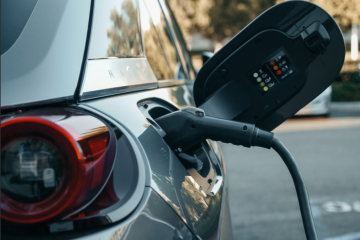 An electric or hybrid car is shown while being charged